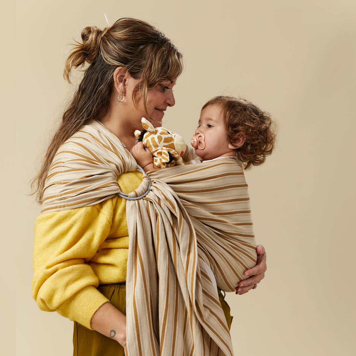A mum babywearing her child in Tula Ring Sling