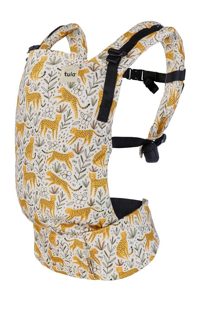 Ergonomic Free-to-Grow Baby Carrier Prowl for Newborns. Jumping cheetahs spring into action across a light cream background. Stenciled flowers fill in the details for this fun and frisky print.