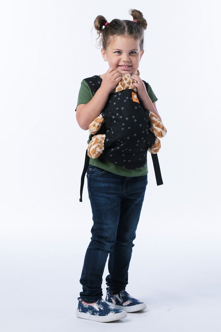 The Tula Mini Toy and Doll Carrier Everblue carried by a little girl.
