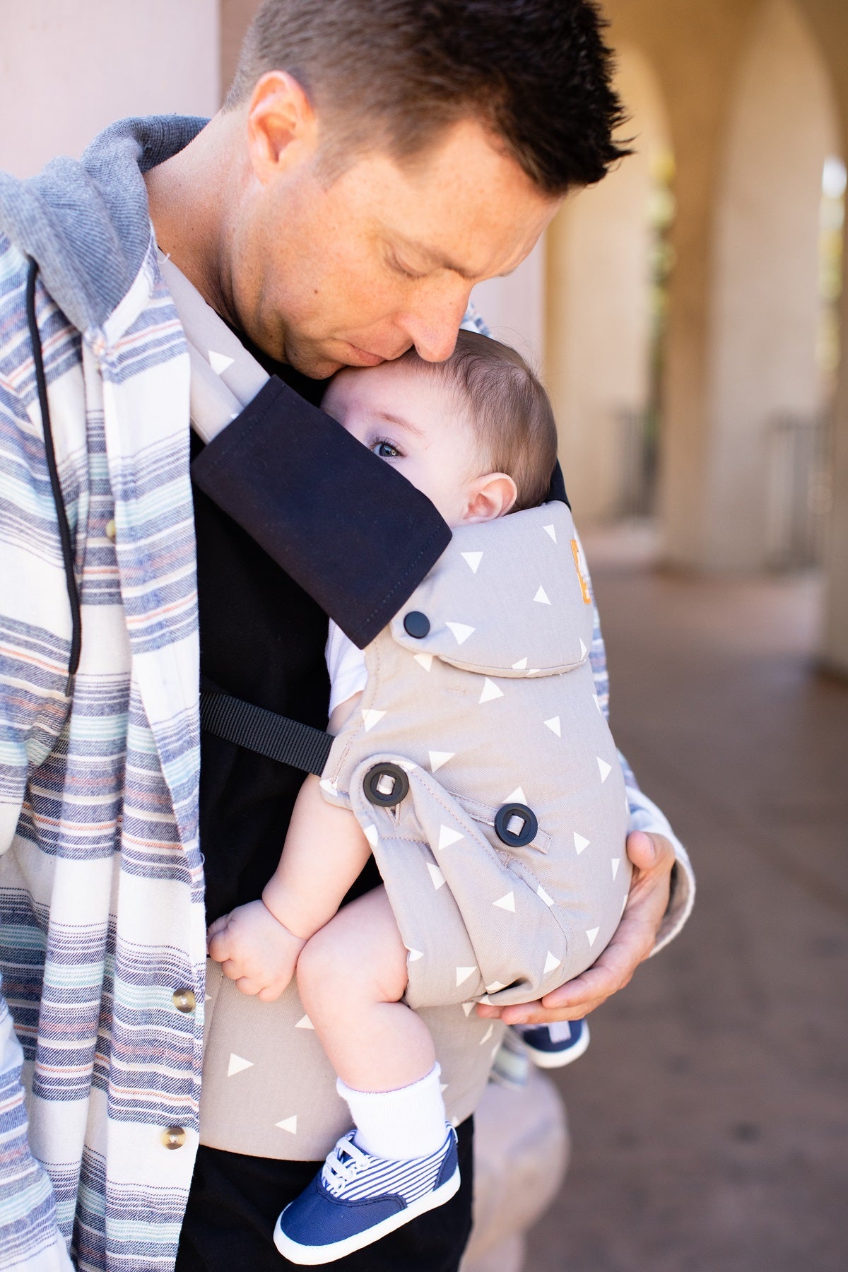 The Droola Strap Covers Urbanista from Tula in black on a Tula Baby Carrier.