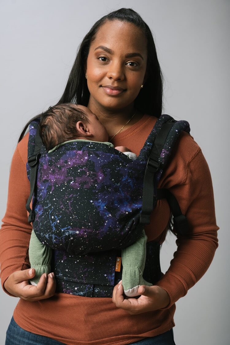A baby sitting in the ergonomic Free-to-Grow Carrier Andromeda while sleeping.
