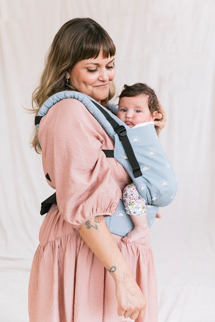 A mother and her child while using Tulas ergonomic Free-to-Grow Baby Carrier Harbor Skies.