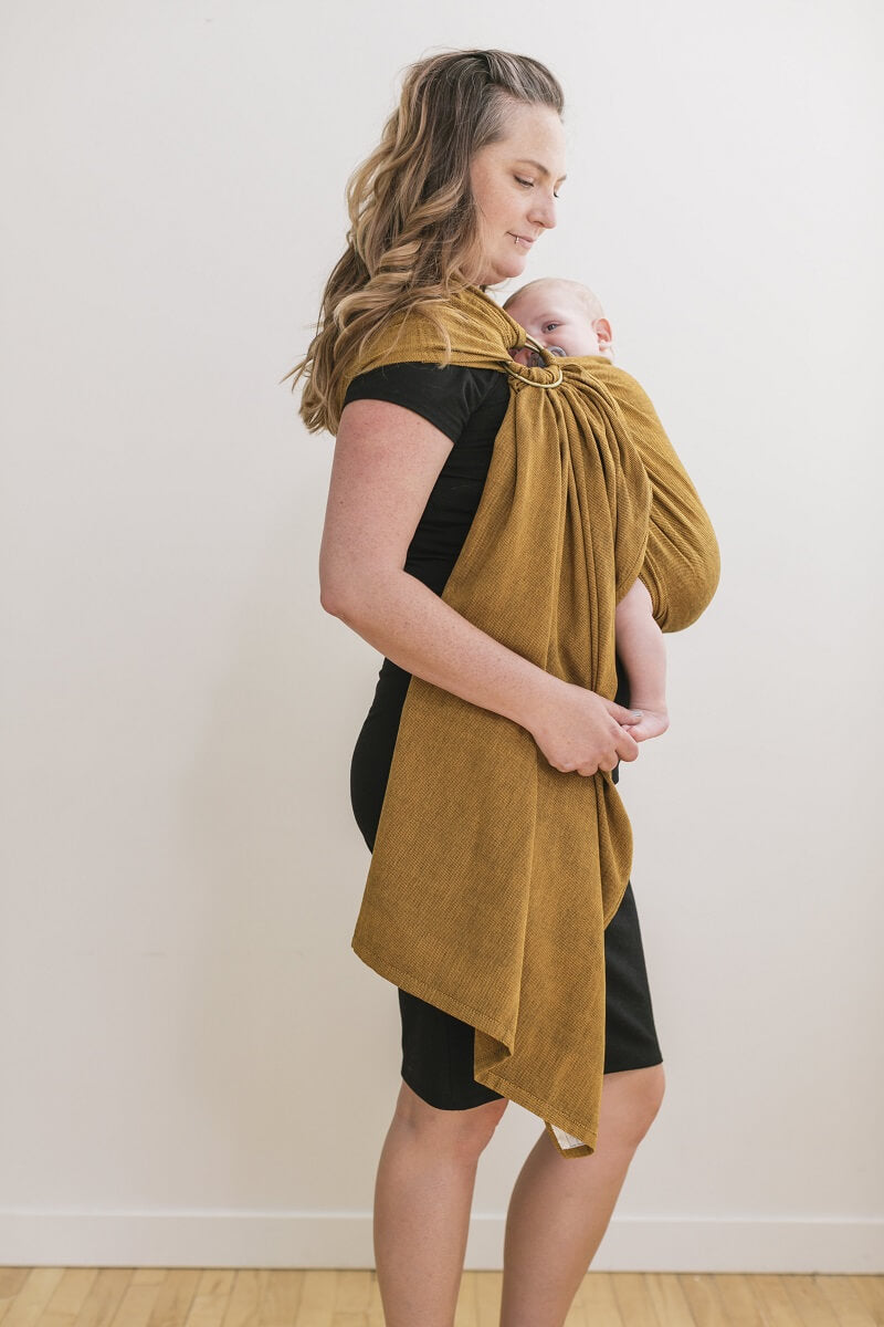 Mum wearing her baby in a Tula Ring Sling newborn carrier from Girasol Camote woven fabric.