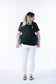 A mother carrying her daughter in back-carry position in the Toddler Carrier Discover from Tula.