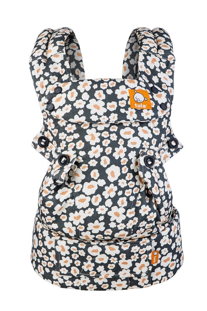 Tula Explore Baby Carrier with floral print over a dark background
