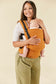 Front view of an infant in a soft baby carrier made from hemp suitable from newborn