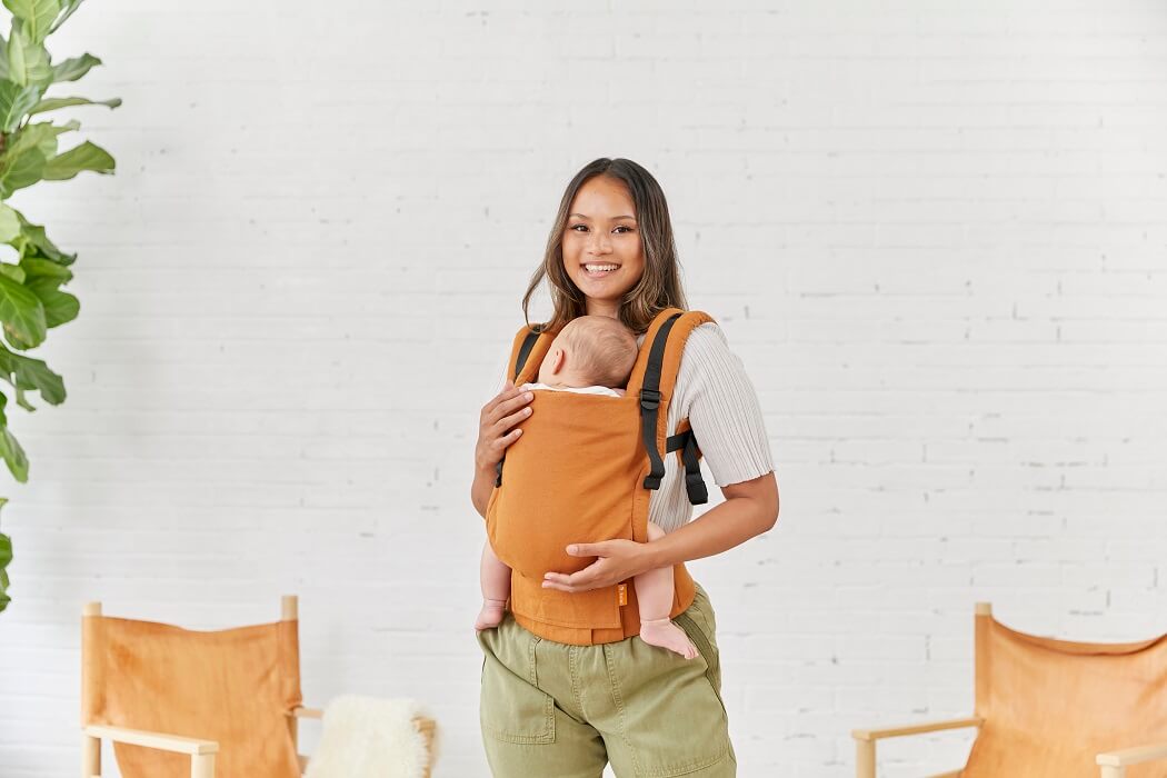 Front view of an infant in a soft baby carrier made from hemp suitable from newborn