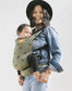 Baby in a ergonomic lightweight baby carrier with swallows in olive green.