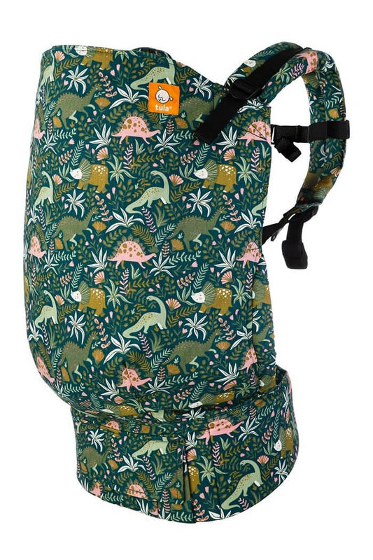 Tula Preschool Carrier with fun, lush print featuring our prehistoric dino friends amongst ferns and plant life on an evergreen backdrop.