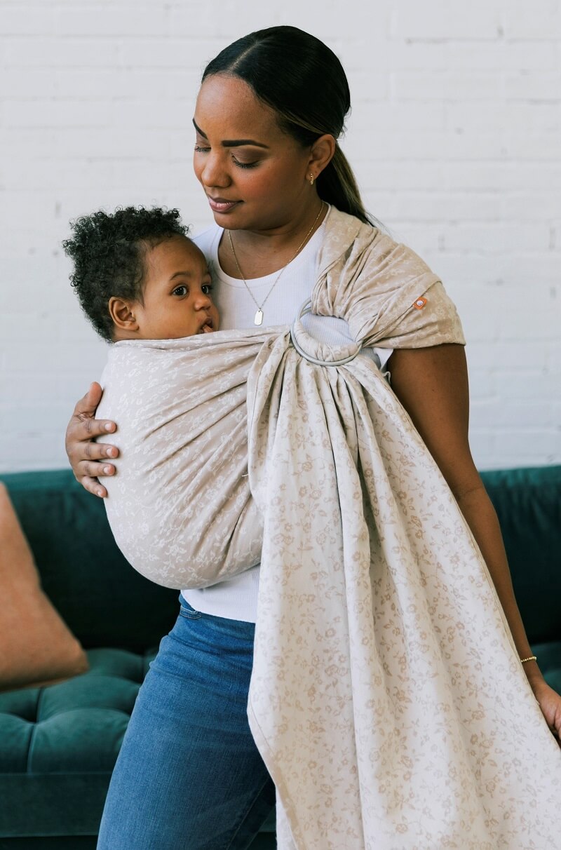 A mother using the Tula Ring Sling Briar.