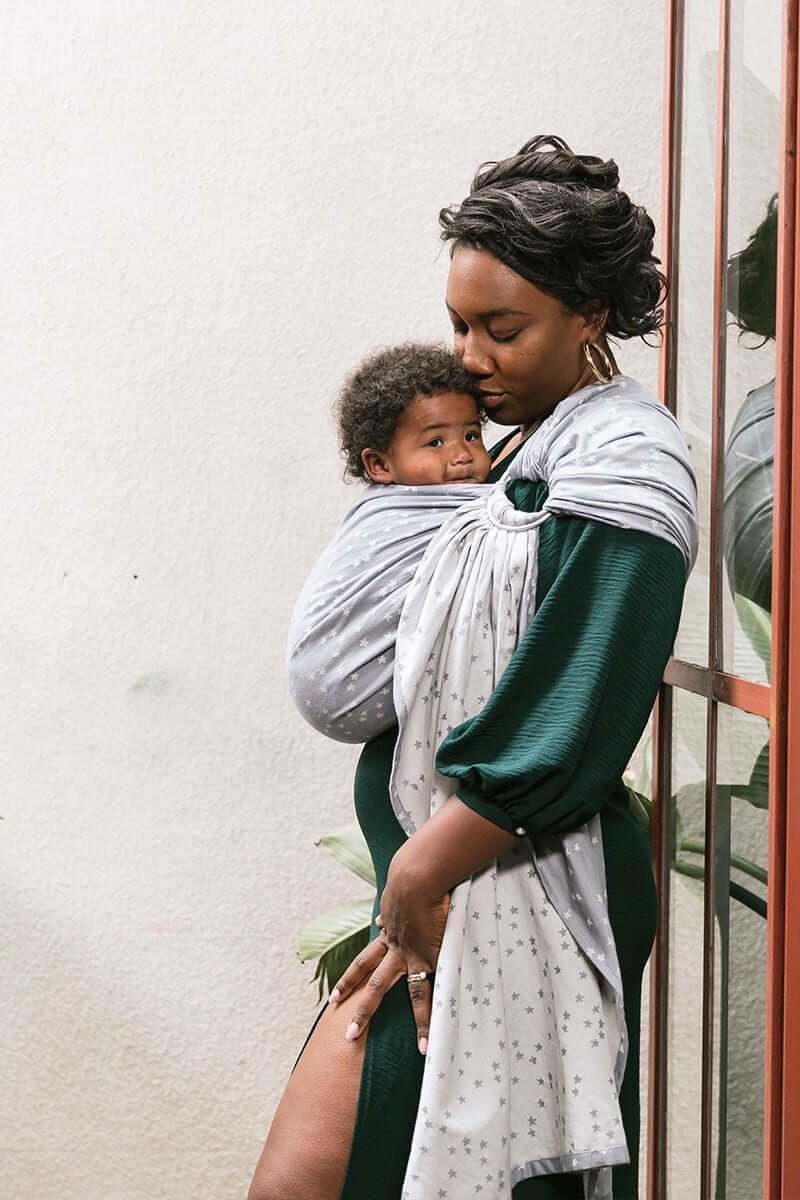 A mother carrying her child in Tula's Ring Sling Stella.