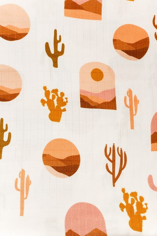 Tula Baby Blanket Desertscape with brown and orage cacti and sunsets.