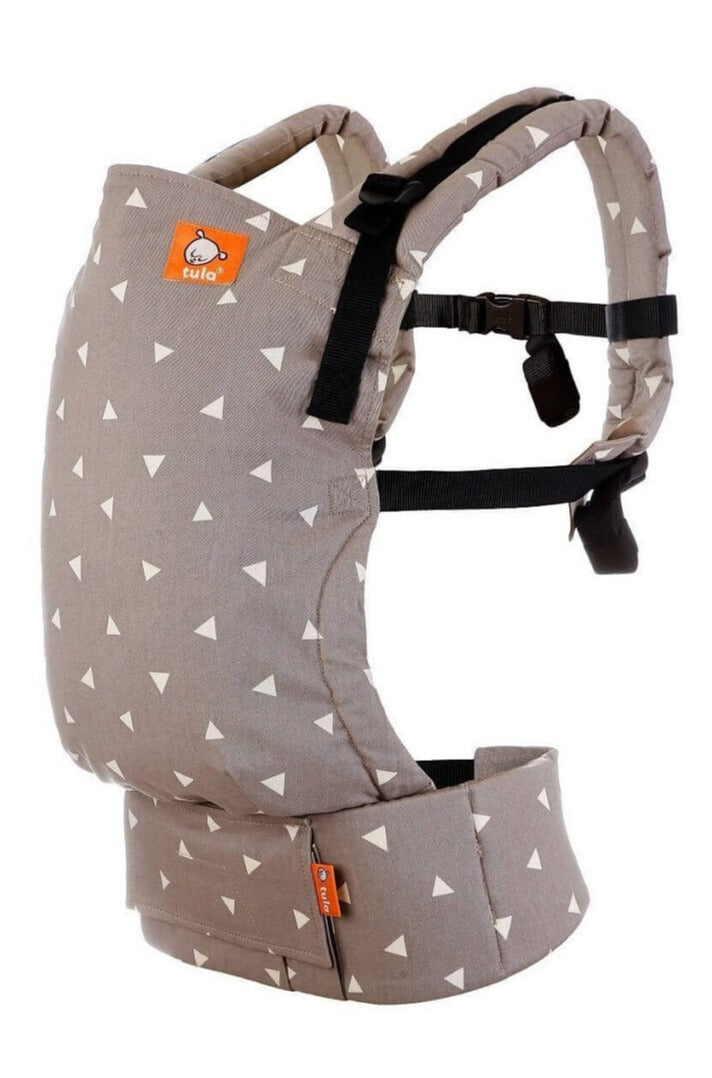 Tula Free-to-Grow Baby Carrier Sleepy Dust with cream triangles across a taupe grey background