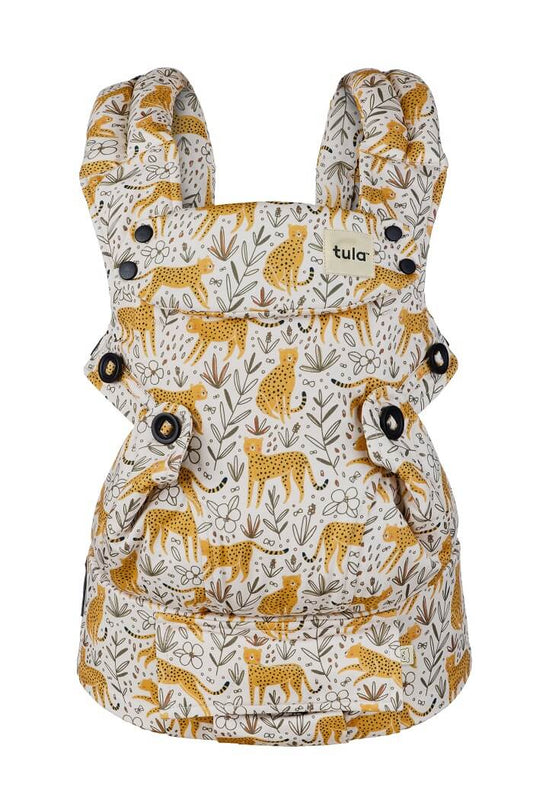 Ergonomic front-facing baby carrier Tula Explore Prowl in light cream with cheetahs and stenciled flowers.