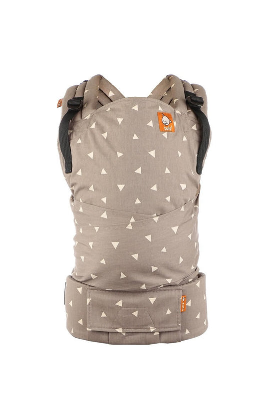 The Tula Half Buckle Carrier Sleepy Dust with a neutral design with off-white triangles sprinkled across a soft gray background.